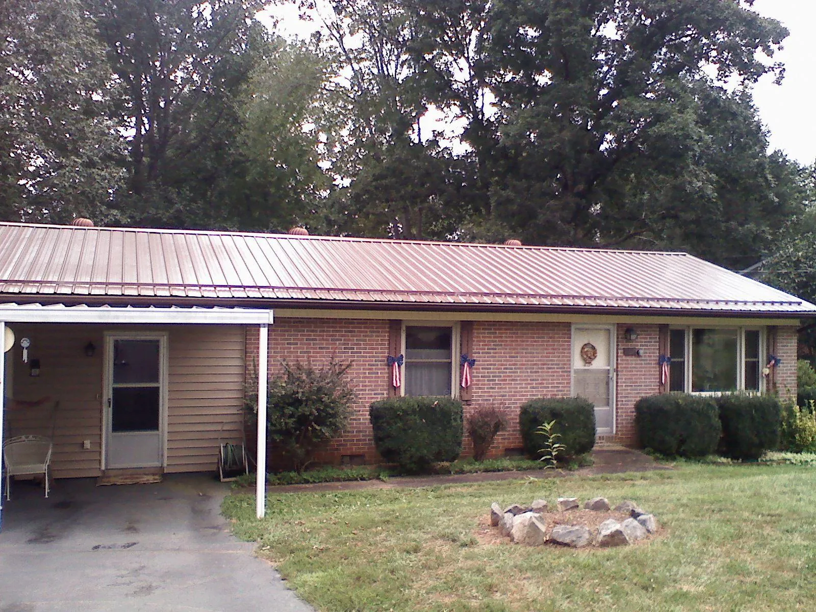 Bronze metal roof and carport on a brick ranch home — Roof Repair work by our crew in West Elkton
